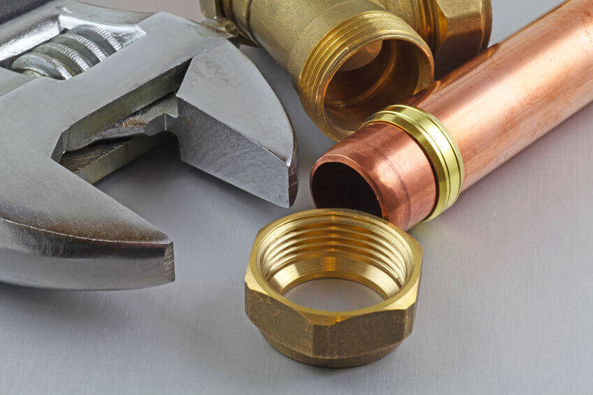 Adjustable spanner and copper pipe used by a heating engineer