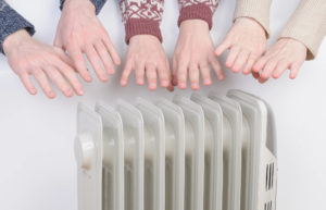 Warming Hands on Electric Radiator